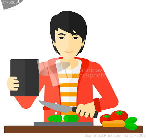 Image of Man cooking meal.