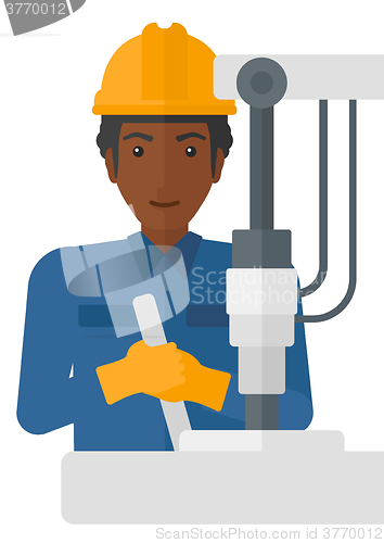 Image of Worker working with industrial equipment.