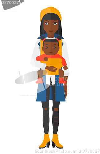 Image of Woman holding baby in sling.