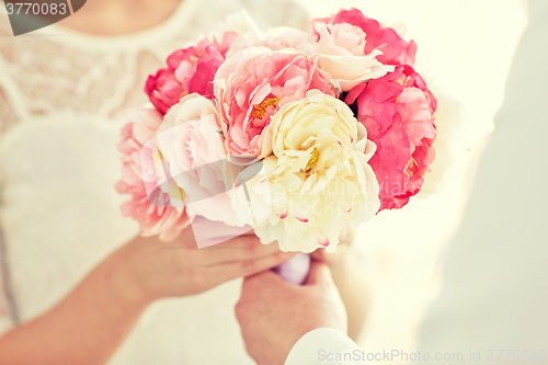 Image of close up of happy lesbian couple with flowers