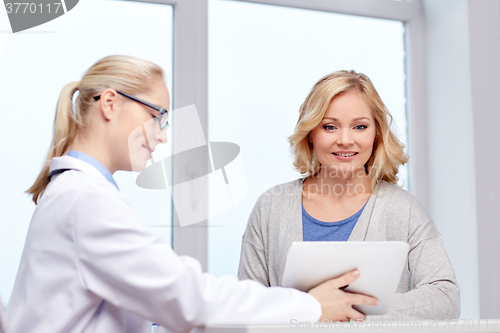 Image of doctor with tablet pc and woman at hospital