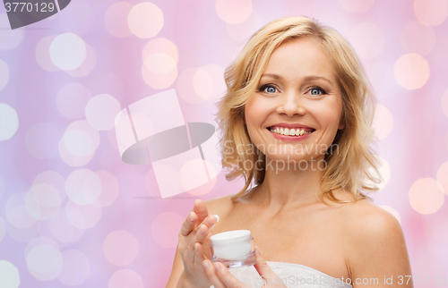 Image of happy woman with cream jar