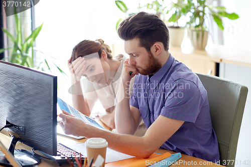 Image of business team with computer and files in office