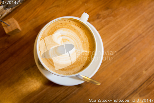 Image of close up of coffee cup with heart shape drawing