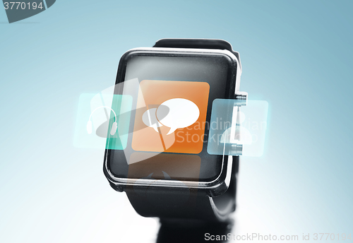 Image of close up of black smart watch with messenger icon