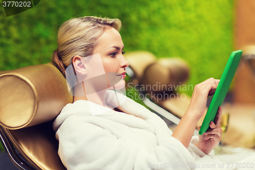 Image of beautiful young woman with smartphone at spa