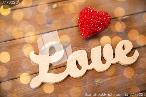 Image of close up of word love with red heart decoration