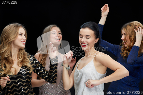 Image of happy young women dancing at night club disco