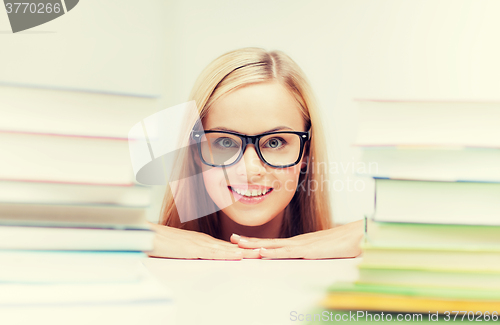 Image of student with stack of books