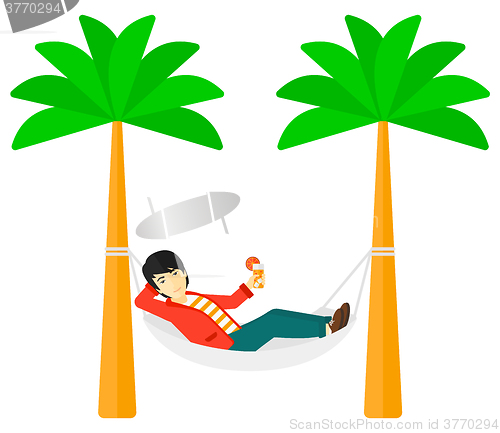 Image of Man chilling in hammock.