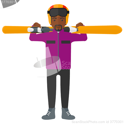 Image of Man holding skis.