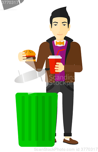 Image of Man throwing junk food.