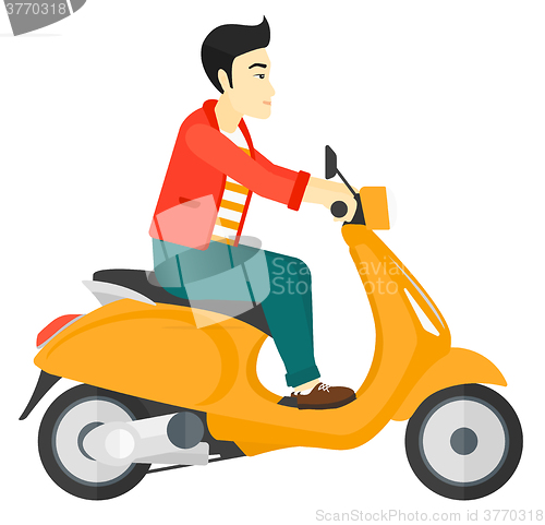 Image of Man riding scooter.