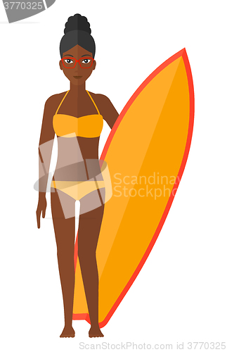 Image of Surfer holding surfboard.