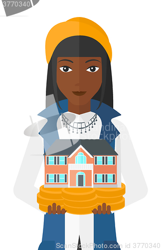 Image of Woman holding house model.