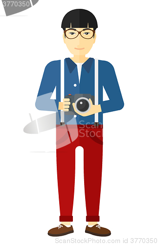 Image of Smiling photographer holding camera.