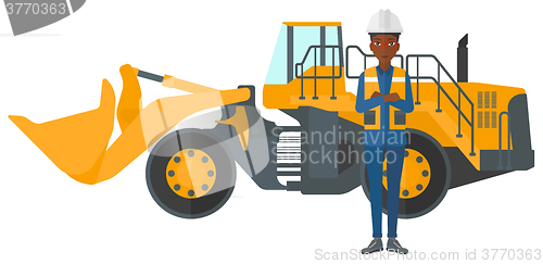 Image of Miner with mining equipment on background.