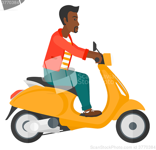 Image of Man riding scooter.