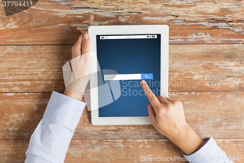 Image of close up of hand with internet search on tablet pc