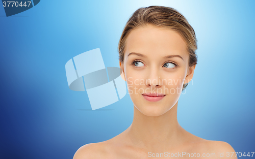 Image of smiling young woman face and shoulders