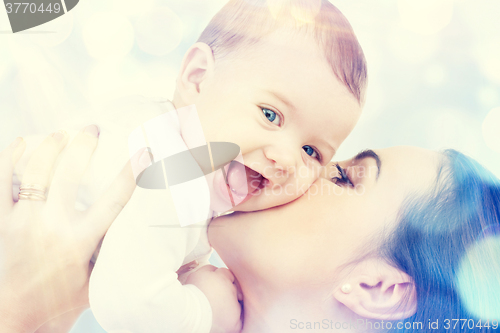 Image of happy mother kissing baby