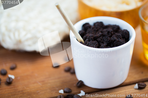 Image of close up of coffee scrub in cup on wooden table