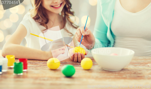 Image of close up of family coloring easter eggs