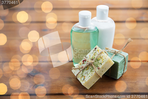 Image of close up of handmade soap bars and lotions on wood