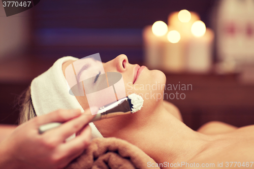 Image of close up of young woman and cosmetologist in spa