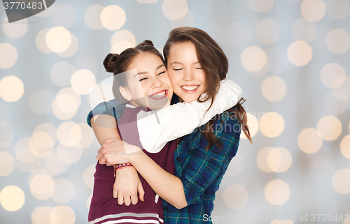Image of happy smiling pretty teenage girls hugging