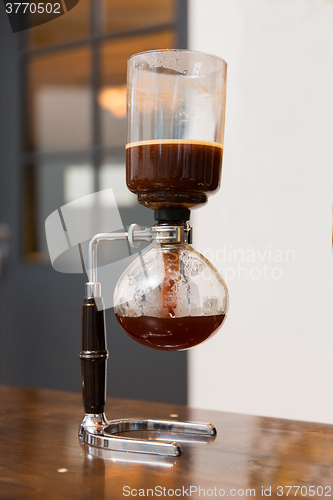 Image of close up of siphon vacuum coffee maker at shop