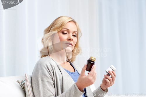 Image of woman with medicine jars at home