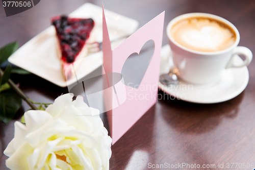 Image of close up of greeting card with heart and coffee