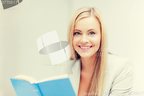 Image of young woman reading book