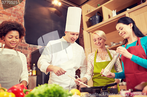 Image of happy women and chef cook cooking in kitchen