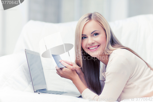 Image of businesswoman with laptop and credit card