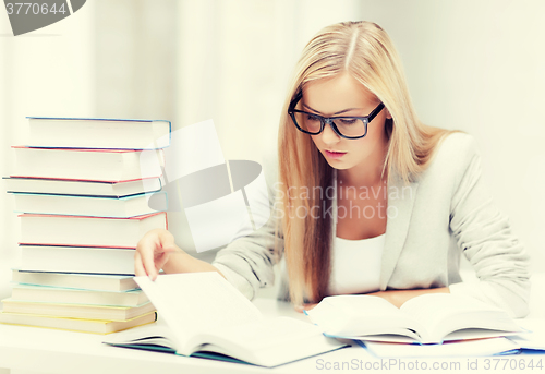 Image of student with books and notes