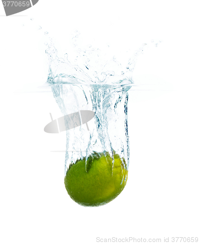 Image of lime falling or dipping in water with splash