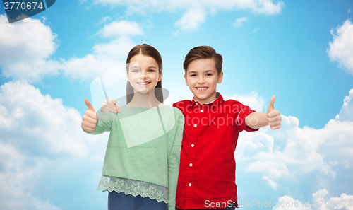 Image of happy boy and girl showing thumbs up