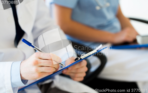 Image of close up of happy doctors at seminar or hospital