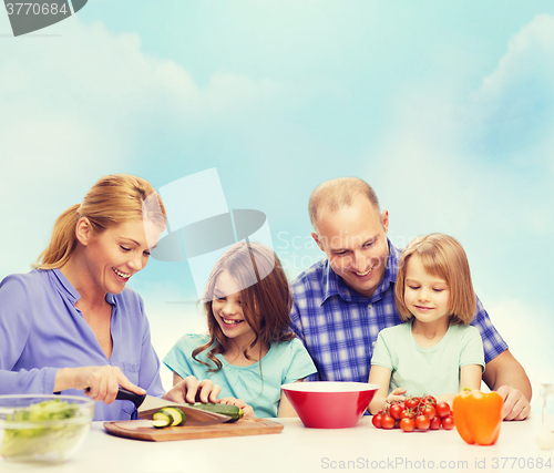 Image of happy family with two kids making dinner at home