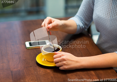 Image of close up of woman with smartphone and coffee