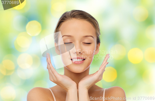 Image of smiling young woman face and hands