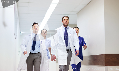 Image of group of medics walking along hospital