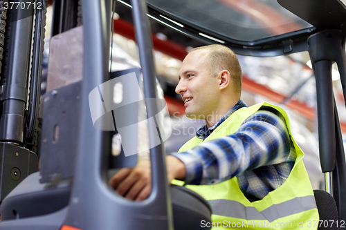 Image of man operating forklift loader at warehouse