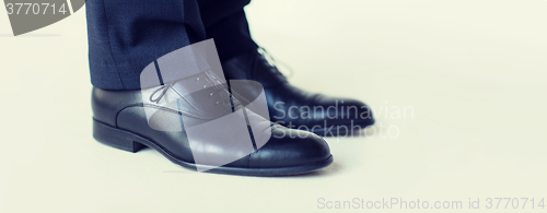 Image of close up of man legs in elegant shoes with laces