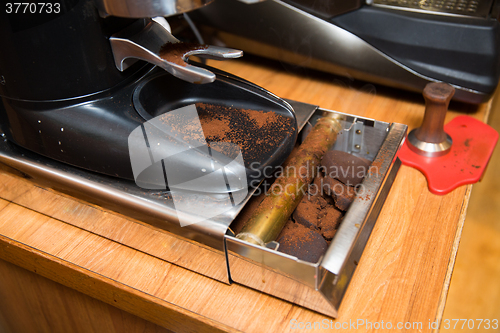 Image of close up of coffee mill box with millcake at cafe