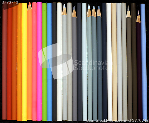 Image of rainbow and grey colored pencils