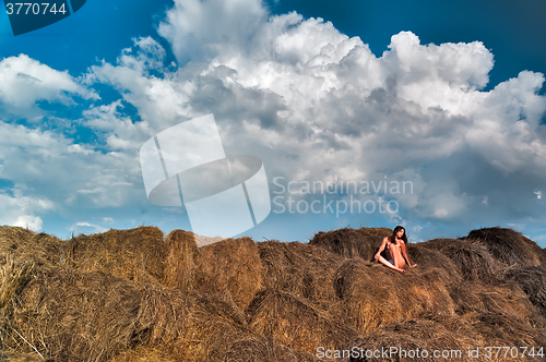 Image of sexy young nude woman on hay