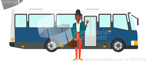 Image of Woman standing near bus.